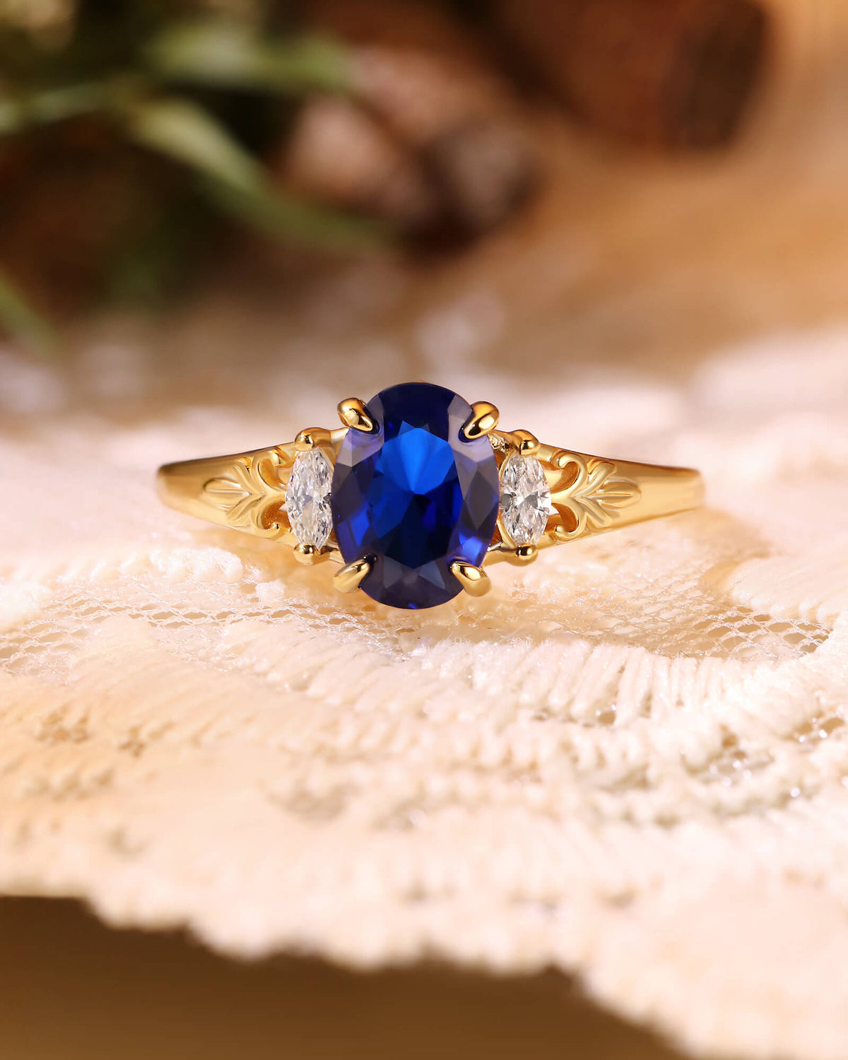 LILIOSA Oval Cut Sapphire Three Stone Fleur-de-lis Engagement Ring