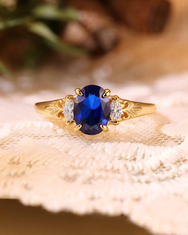 LILIOSA Oval Cut Sapphire Three Stone Fleur-de-lis Engagement Ring