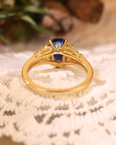 LILIOSA Oval Cut Sapphire Three Stone Fleur-de-lis Engagement Ring
