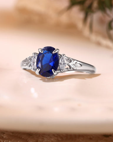 LILIOSA Oval Cut Sapphire Three Stone Fleur-de-lis Engagement Ring