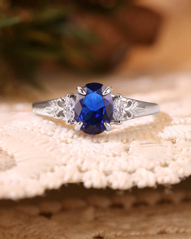LILIOSA Oval Cut Sapphire Three Stone Fleur-de-lis Engagement Ring