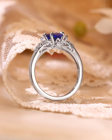 LILIOSA Oval Cut Sapphire Three Stone Fleur-de-lis Engagement Ring