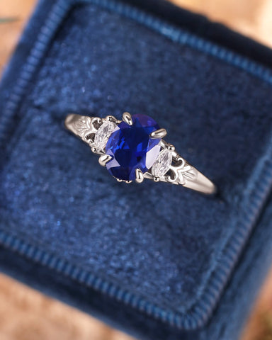 LILIOSA Oval Cut Sapphire Three Stone Fleur-de-lis Engagement Ring